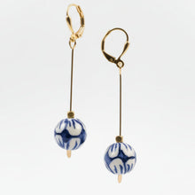 Load image into Gallery viewer, Pair of earrings with blue and white patterned beads on a light gray background
