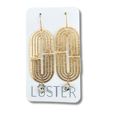 Load image into Gallery viewer, Gold arch-shaped earrings on a Luster branded card

