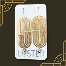 Load image into Gallery viewer, Gold earrings with stone drops on a Luster branded card against a dark background
