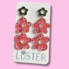 Load image into Gallery viewer, Floral earrings on a Luster branded card against a pink background
