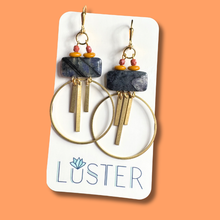 Load image into Gallery viewer, Pair of brass and stone hoop earrings on a Luster branded card against an orange background
