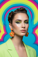 Load image into Gallery viewer, Woman with colorful makeup and earrings against a vibrant, multicolored background
