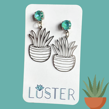 Load image into Gallery viewer, Potted plant-shaped earrings on a Luster branded card with a teal background
