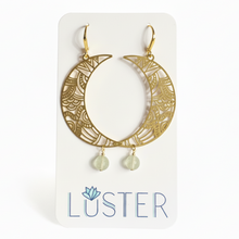 Load image into Gallery viewer, Gold crescent moon earrings with dangling beads on a Luster branded card.
