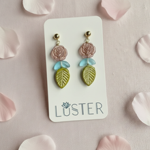 Load image into Gallery viewer, Pair of floral earrings on a Luster branded card with pink petals around
