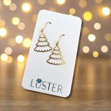 Load image into Gallery viewer, Brass earrings in the shape of snowy trees with French earhooks, displayed on a white card with the brand name 'LUSTER'.

